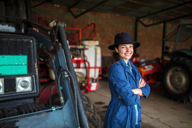 istock Mechanic woman in farm garage 1129897546