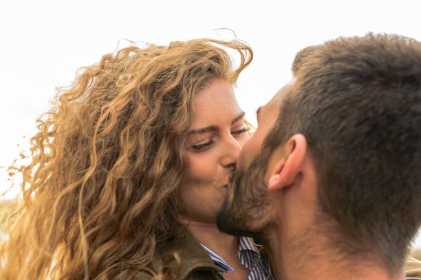 Close-up view of young couple kissing stock photo