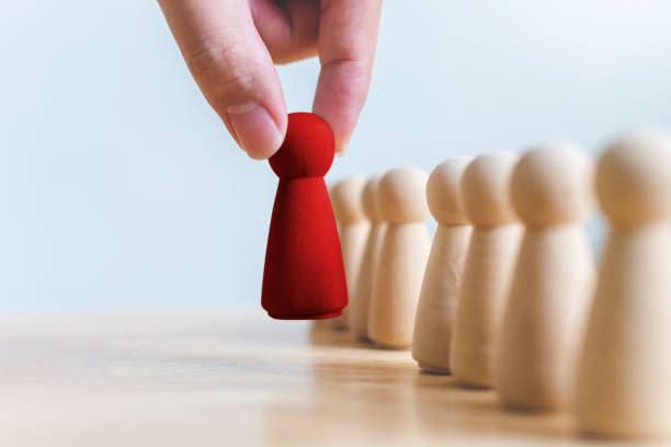 human resource, talent management, recruitment employee, successful business team leader concept. hand chooses a wooden people standing out from the crowd. - individuality standing out from the crowd contrasts competition imagens e fotografias de stock