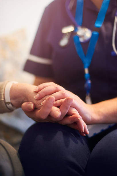 istock Nurse on home visit comforting senior patient 1129903027