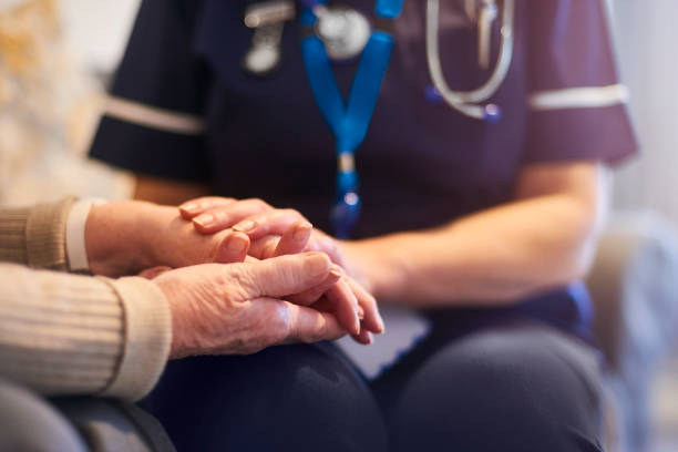 istock Nurse comforting senior patient 1129903107