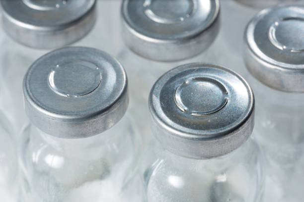 istock Bottles for injection with white powder close-up 1129906247
