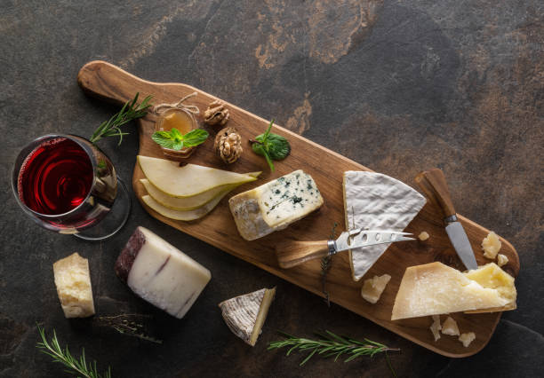 istock Cheese platter with organic cheeses, fruits, nuts and wine. 1129908321