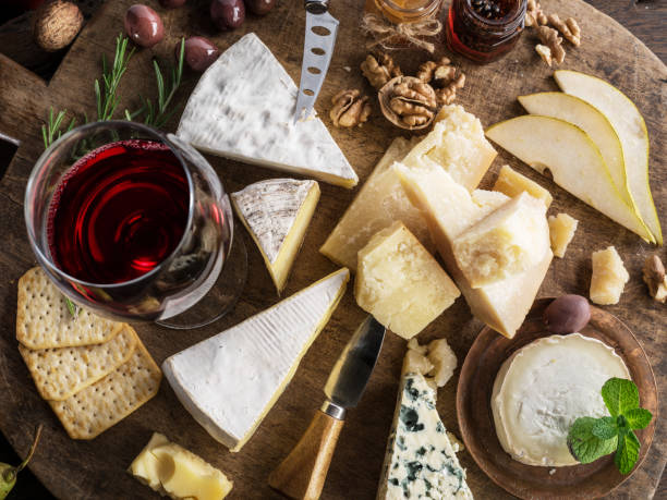 istock Cheese platter with organic cheeses, fruits, nuts and wine. 1129909325