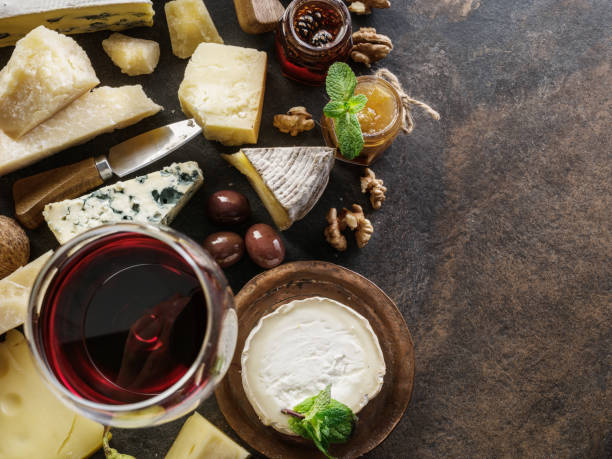 istock Cheese platter with organic cheeses, fruits, nuts and wine. 1129912781