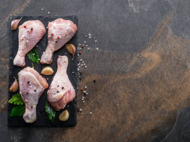 istock Chicken legs with spices and salt  ready for cooking. 1129915032