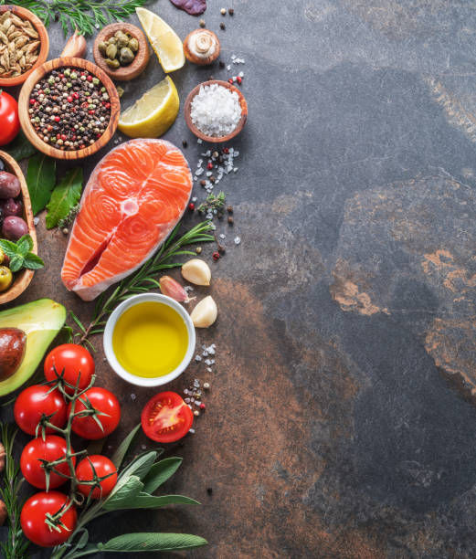 istock Raw salmon with spices and vegetables. 1129915878