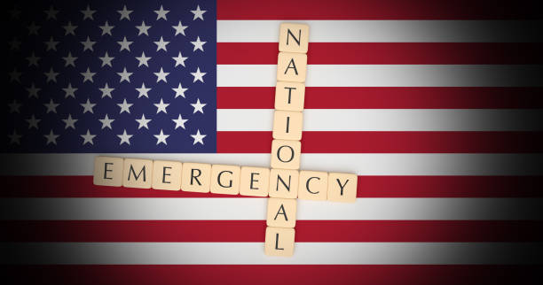 istock Letter Tiles National Emergency On US Flag, 3d illustration 1129916884