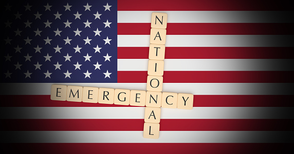 USA Politics News Concept: Letter Tiles National Emergency On US Flag, 3d illustration
