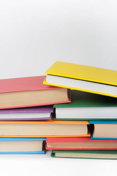 istock Book stacking. Open book, hardback books on white background. Back to school. Copy space for text. 1129917350
