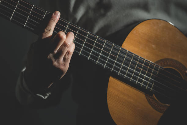 istock Midsection Of Man Playing A Guitar 1129918244