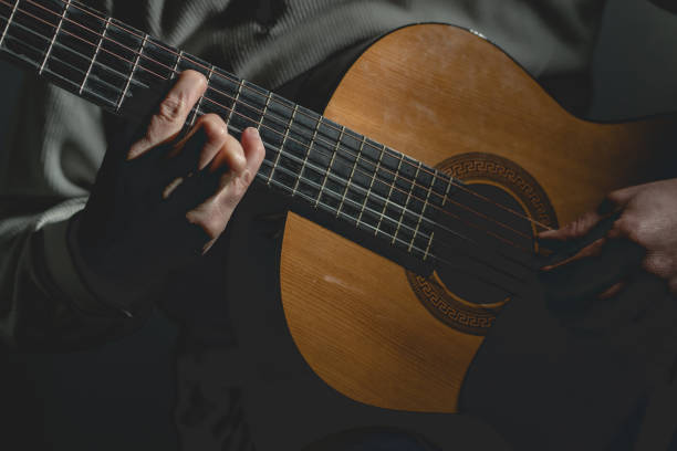 istock Midsection Of Man Playing A Guitar 1129918282