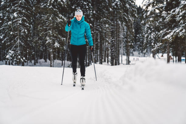 istock Cross-country skiier gliding on the slopes 1129918296