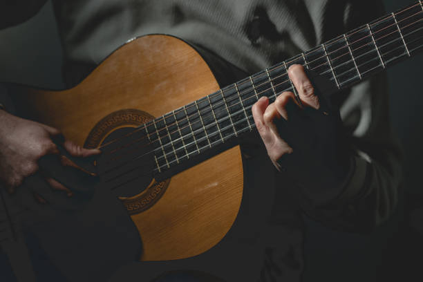 istock Midsection Of Man Playing A Guitar 1129918344