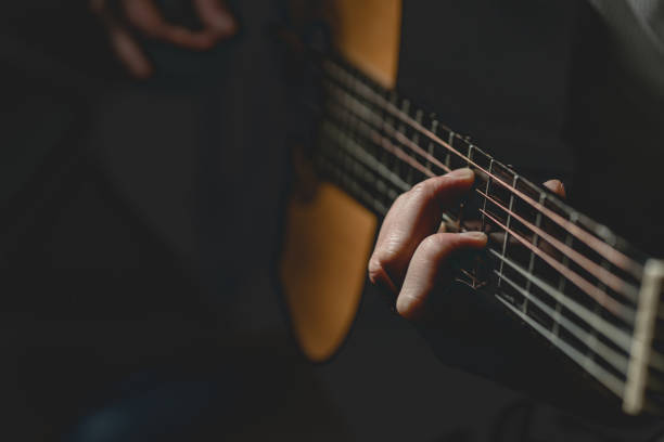 istock Midsection Of Man Playing A Guitar 1129918500