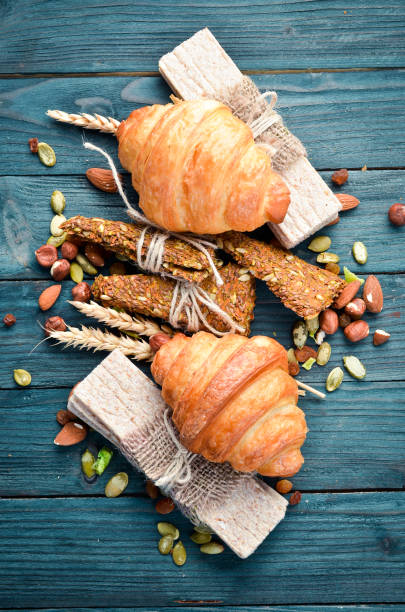 istock Croissants with chocolate and nuts on the old table. Top view. Free space for your text. 1129918577