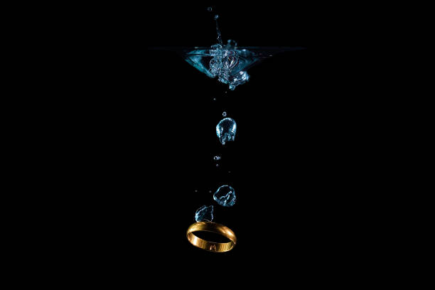 Golden wedding ring falling into the water in the bubbles 2019