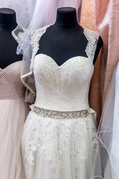istock Close-up on white wedding dress on mannequin 1129926309