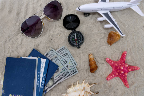 istock Passports with tickets on sand with toy plane 1129926330
