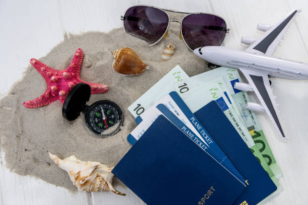 istock Travelling concept on light background with toy airplane 1129926699