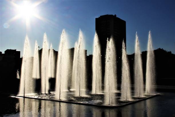 Fountain by the River Manzanares, Madrid, Spain Sparkling water fountains against the sun. paisaje urbano stock pictures, royalty-free photos & images