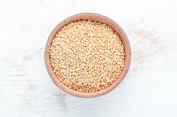istock White quinoa On a white wooden background. Top view. Free copy space. 1129928014