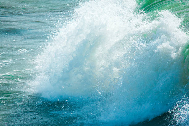 istock surface of turquoise ocean water with waves, spray and white foam 1129929027