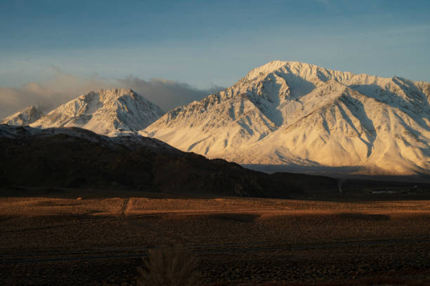 istock snowy mountain peaks, hills, desert valley landscape 1129929110