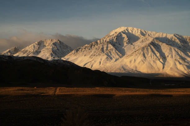 istock snowy mountain peaks, hills, desert valley landscape 1129929129