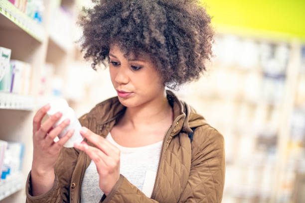 istock Young woman in a drugstore 1129931075