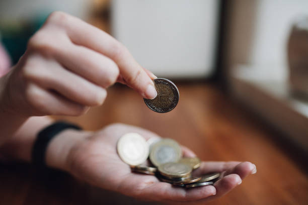 Woman counting coins in her hand