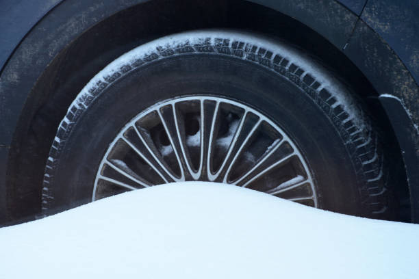 istock Car Tires in Deep Snow in a Snowstorm Abstract 1129935506