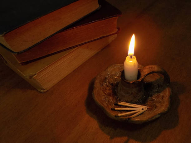 Matches next to lit candle and books Here the elements are part of a more elaborate composition and show how they can be used. inflamable stock pictures, royalty-free photos & images