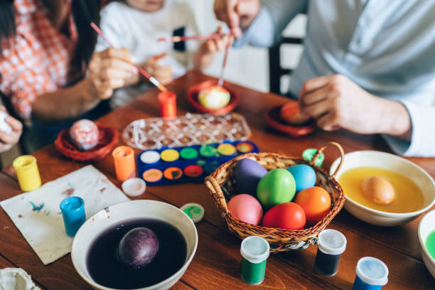 istock Family painting Easter eggs 1129939427