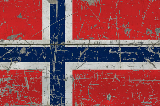 Grunge Norway flag on old scratched wooden surface. National vintage background.
