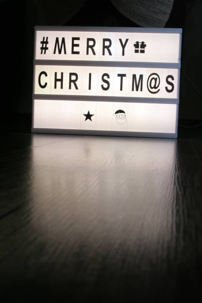 istock Christmas greetings note on a light board. Christmas greetings. 1129955066