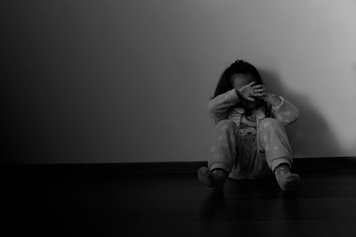 little girl sitting on the floor crying, black and white illustration
