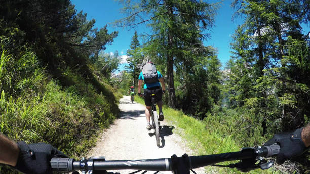istock Riding a fast single trail in the forest 1129965037