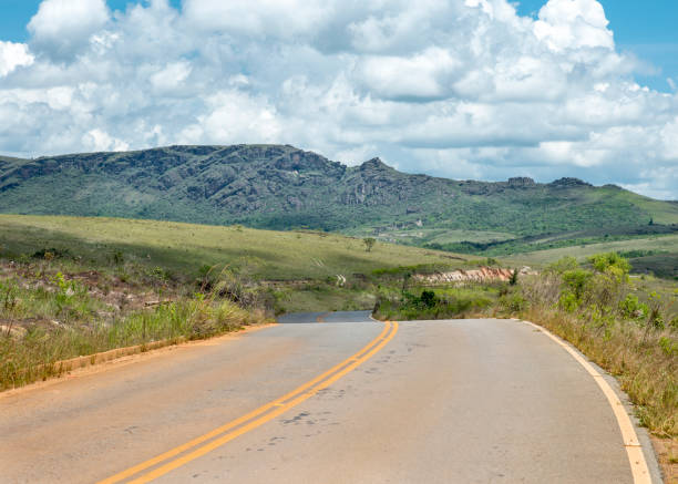istock Windy empty country road Itacolomi park wighway 1129969212