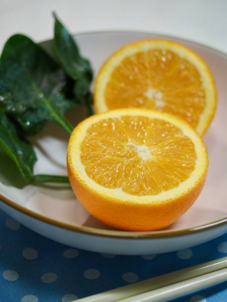 Orange and spinach in a ceramic bowl Shot in studio 깨끗한 stock pictures, royalty-free photos & images