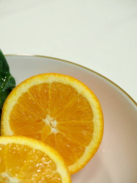 Orange and spinach in a ceramic bowl Shot in studio 깨끗한 stock pictures, royalty-free photos & images