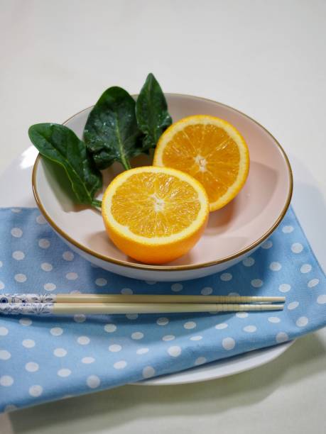 Orange and spinach in a ceramic bowl Shot in studio 깨끗한 stock pictures, royalty-free photos & images