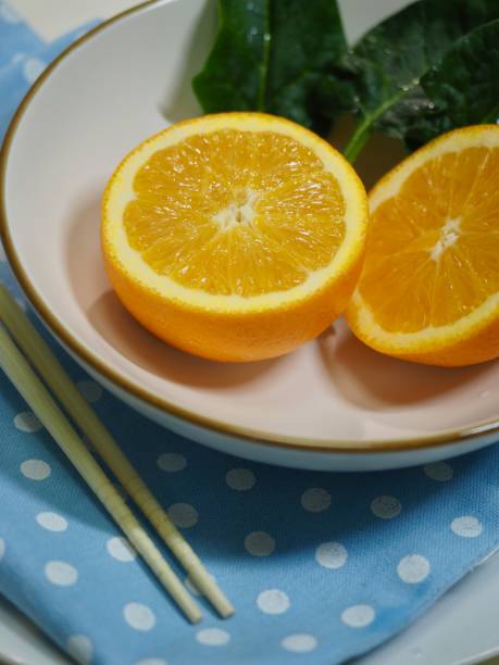 Orange and spinach in a ceramic bowl Shot in studio 깨끗한 stock pictures, royalty-free photos & images