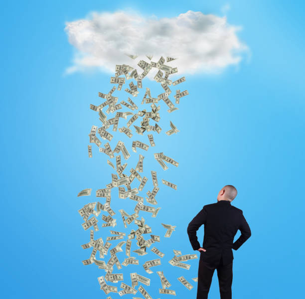istock Young Man Under Rain of Money 1129974345