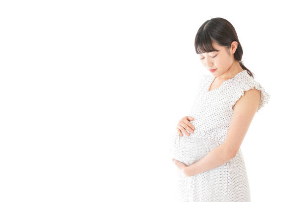 istock Pregnant woman standing 1129981404