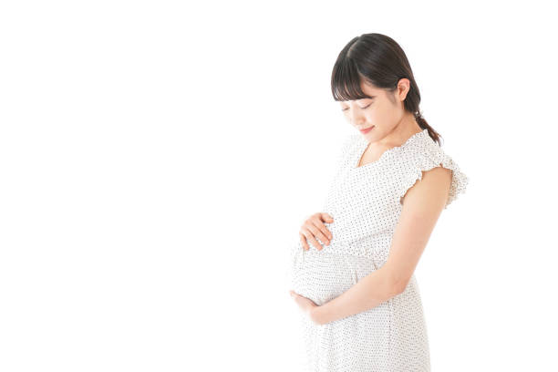 istock Pregnant woman standing 1129981437