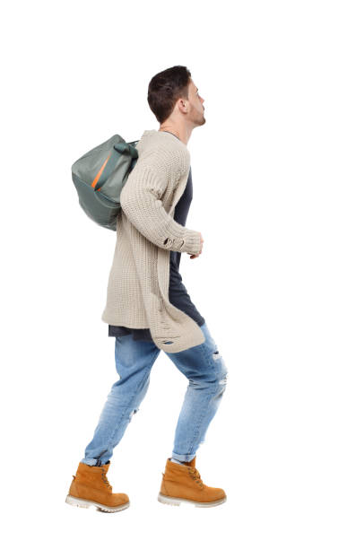 istock Side view of a running man with a green bag. 1129985657