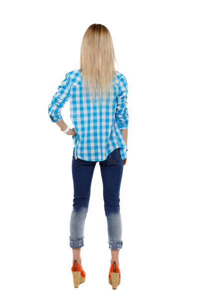 istock Back view of a woman in jeans. 1129986317