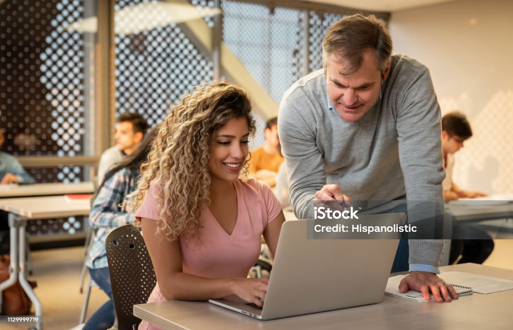 Student Pointing Screen Beautiful Student Using A Laptop During Class And Teacher Pointing ...