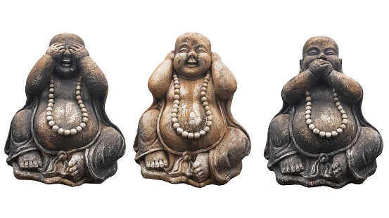 Three Buddha statues in a pose of three wise monkeys \